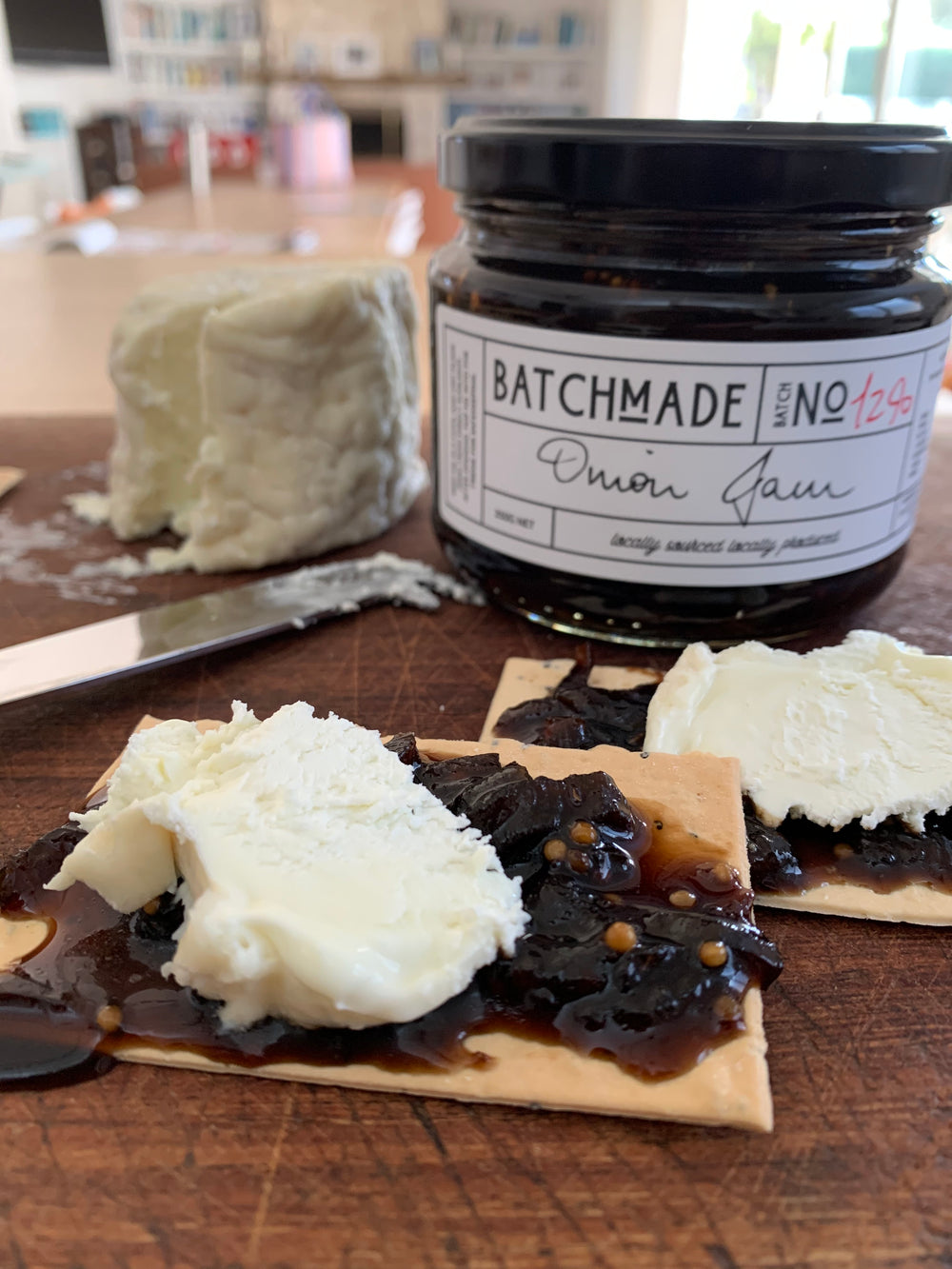 BatchMade onion jam with goats cheese on a cracker